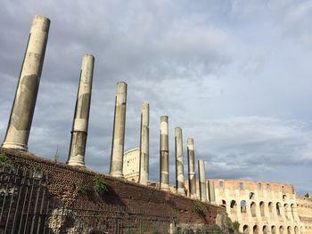 Low angle view of historical building against cloudy sky