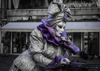 Woman wearing costume standing outdoors