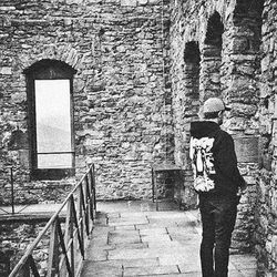 Man standing in front of brick wall