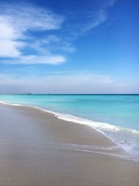 Scenic view of beach against blue sky