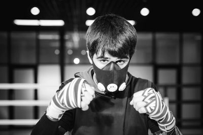 Portrait of man in mask practicing at boxing ring