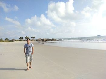 Men walking and posing on the beach