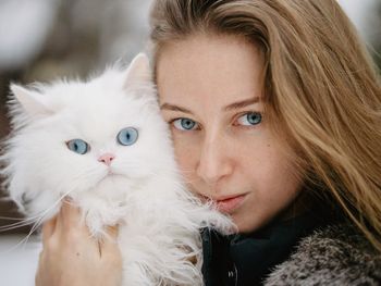 Portrait of beautiful woman with cat