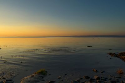 Scenic view of sea against sky at sunset