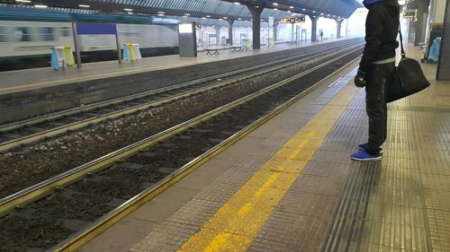 Man waiting at railroad station