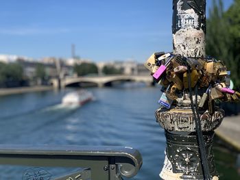 Close-up of padlocks on bridge over river