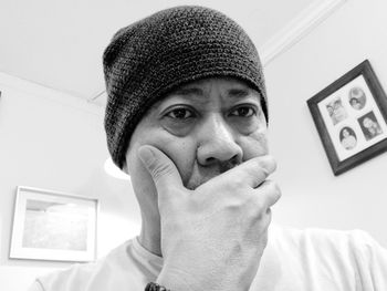 Close-up portrait of mature man wearing knit hat at home