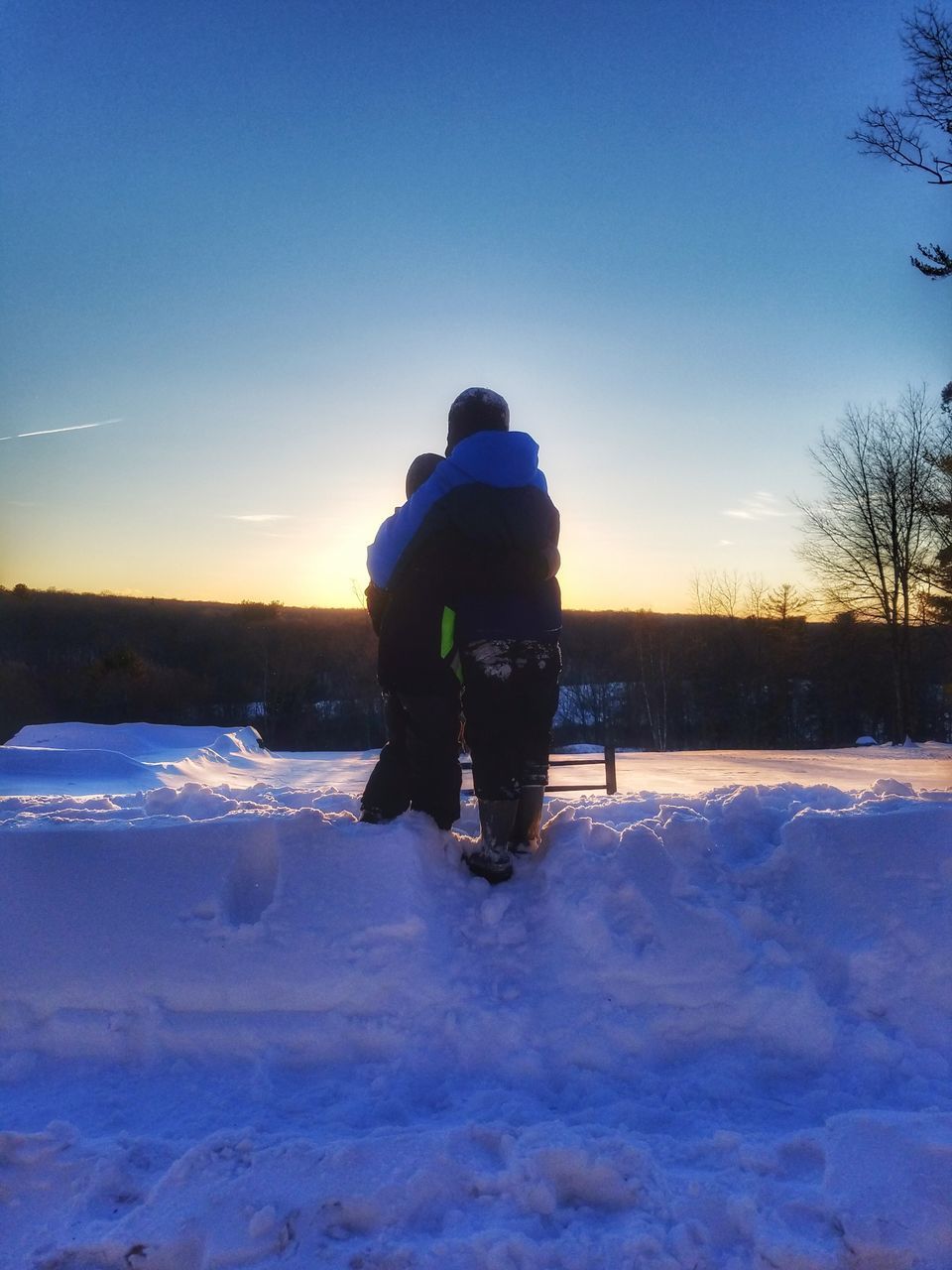 MAN WITH UMBRELLA ON SNOW AGAINST SKY