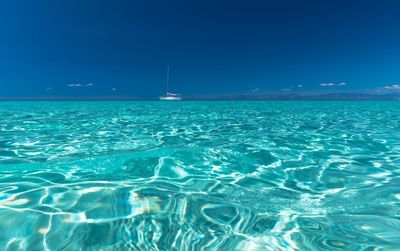 Scenic view of sea against clear blue sky