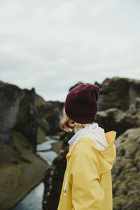 Rear view of woman standing against sky