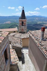 Historic building by mountains against sky