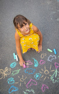 High angle view of girl playing with toys on street