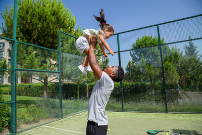 Ethnic father and daughter celebrating victory