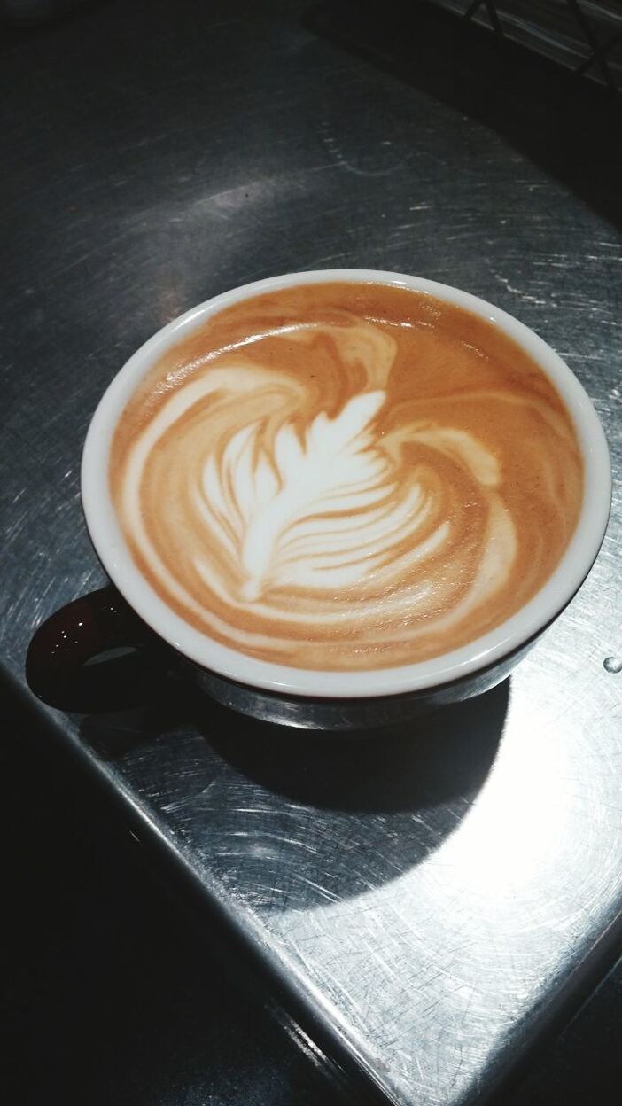 coffee cup, drink, food and drink, refreshment, coffee - drink, froth art, saucer, frothy drink, cappuccino, table, freshness, indoors, coffee, latte, still life, close-up, high angle view, cup, spoon, heart shape