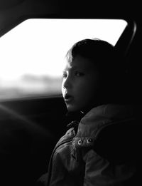 Portrait of boy looking away while sitting in car
