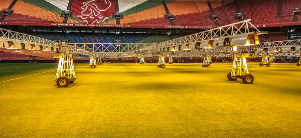 View of soccer field against yellow wall