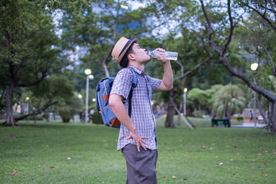 Full length of young man standing in park