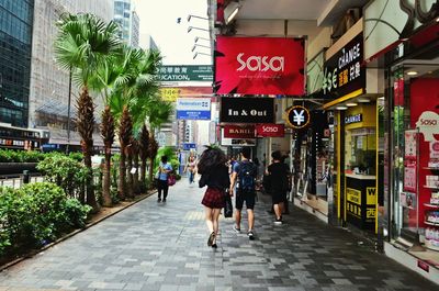 People walking on street in city