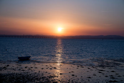 Scenic view of sea against sky at sunset