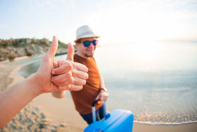 Cropped hand of man holding umbrella