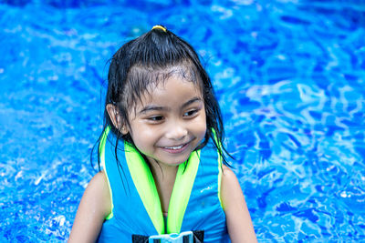 Portrait of smiling girl swimming in pool