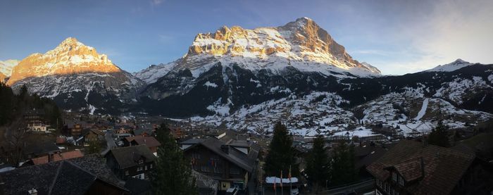 Panoramic view of buildings and mountains against sky