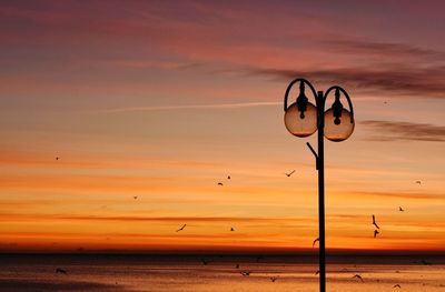 Scenic view of beach against sky during sunset