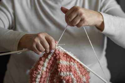 Midsection of man holding wool