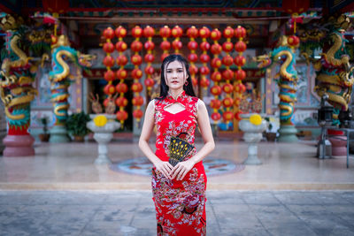 Portrait of a young woman standing outdoors