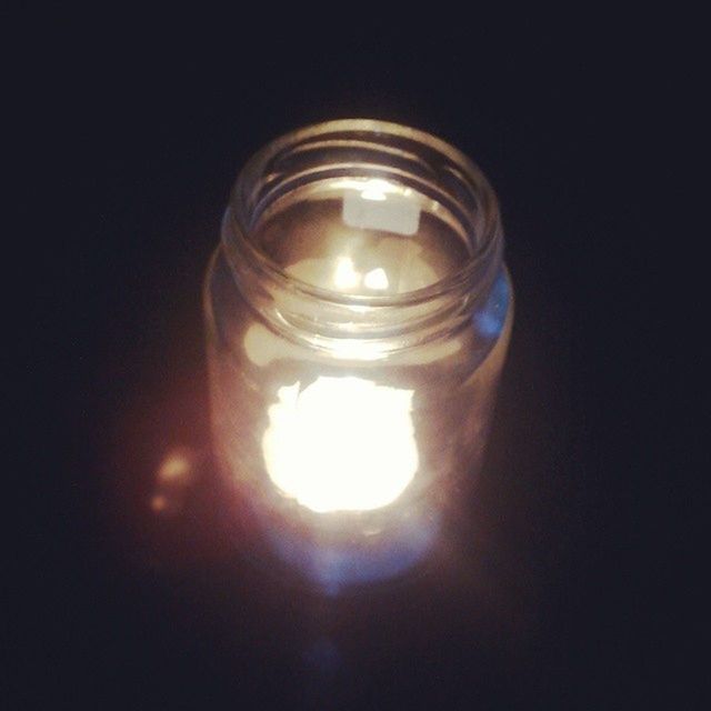 indoors, illuminated, glowing, lighting equipment, close-up, light bulb, electricity, glass - material, flame, studio shot, lit, burning, copy space, candle, light - natural phenomenon, no people, dark, electric light, reflection, low angle view