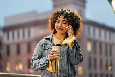 Portrait of young woman drinking coffee