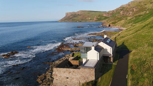 Scenic view of sea and buildings against sky