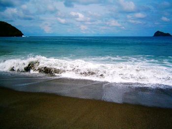Scenic view of sea against cloudy sky
