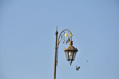 Low angle view of lamp post against clear sky
