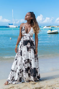 Young woman standing at beach