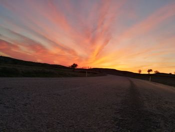 Road against sky at sunset