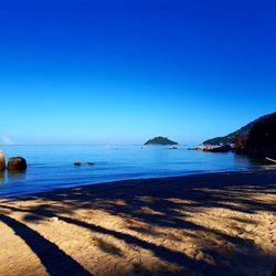 Scenic view of sea against clear blue sky