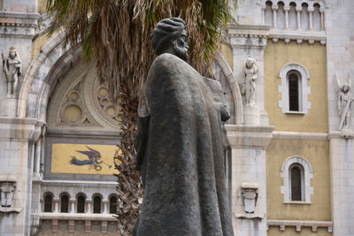 Low angle view of statue against historic building