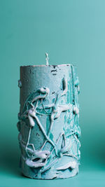 Close-up of carvings on blue table against white background