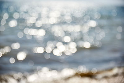 Abstract blurred background with a view of the sea and a bright sun and rays, a view to the distance