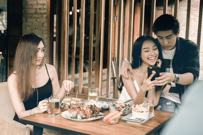 Young woman sitting at restaurant table