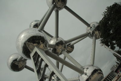 Low angle view of old wheel against sky