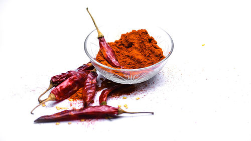 Close-up of red chili peppers in plate on table