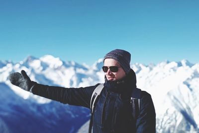 Man standing on snowcapped mountain