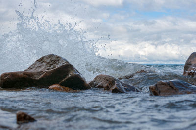 Water splashing on rocks in sea