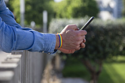 Close-up of man holding mobile phone