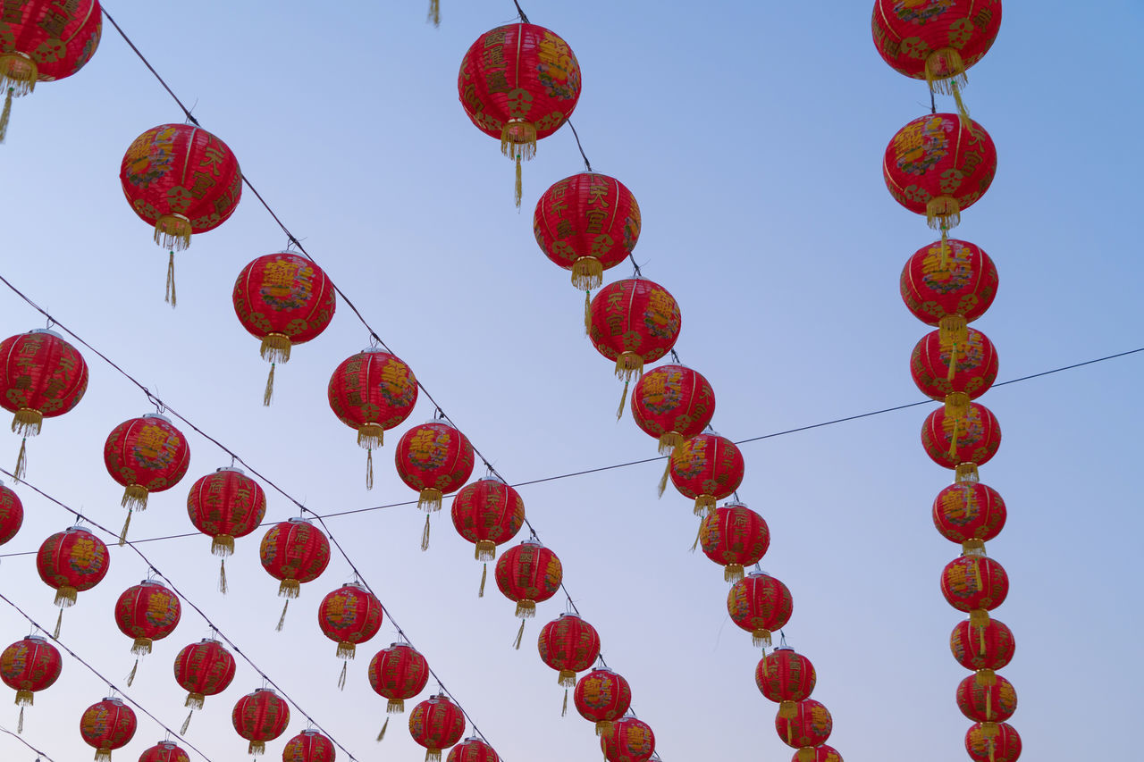 LOW ANGLE VIEW OF RED LANTERNS HANGING AGAINST SKY