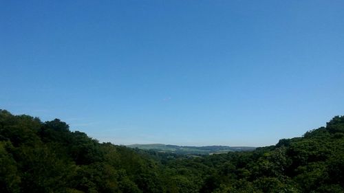 Scenic view of mountains against blue sky