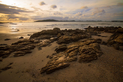 Scenic view of beach against sky during sunset