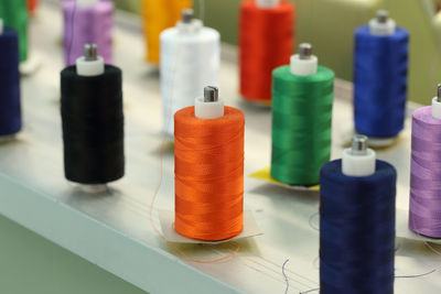 Close-up of multi colored bottles on table